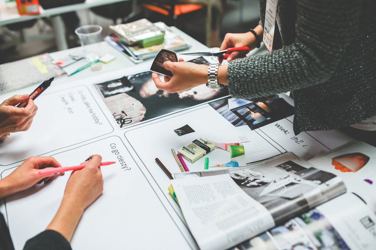Creative workspace with brand identity elements including colour swatches, typography samples, and design tools